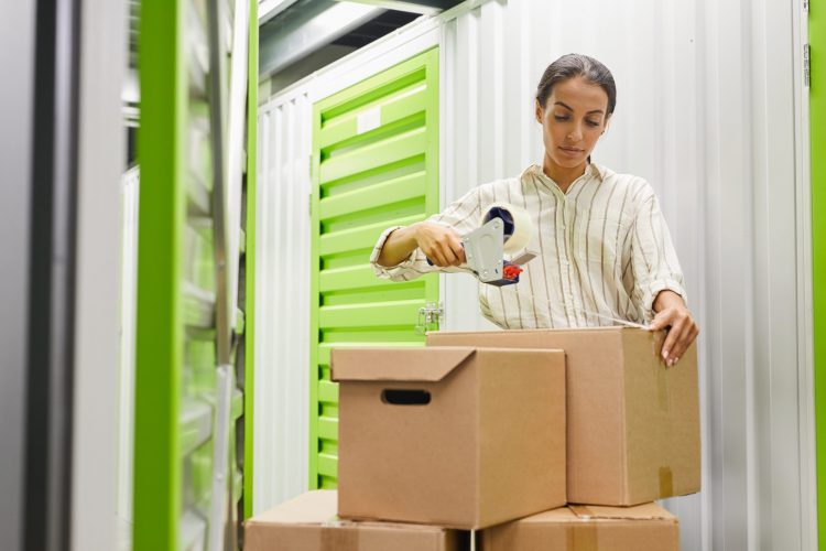 Woman Packing Boxes in Storage Unit